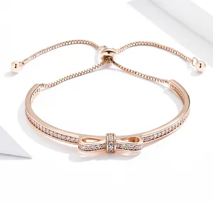 Ezüst rózsa kivert masnis karkötő